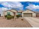 Charming single-story home featuring low maintenance landscaping, a two car garage, and neutral color palette at 17017 N Palo Azul Rd, Maricopa, AZ 85138