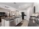 Open kitchen featuring a large island, stainless steel appliances, and sleek finishes at 17017 N Palo Azul Rd, Maricopa, AZ 85138