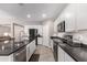 Modern kitchen showcasing white cabinets, stainless steel appliances, and dark countertops at 17017 N Palo Azul Rd, Maricopa, AZ 85138