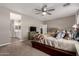 Comfortable main bedroom with neutral colors, soft carpet, and a spacious layout at 17017 N Palo Azul Rd, Maricopa, AZ 85138