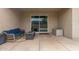 Comfortable covered patio with a cushioned couch, fire pit, and convenient storage box, ideal for relaxing outdoors at 17017 N Palo Azul Rd, Maricopa, AZ 85138