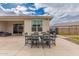 Cozy patio area featuring a dining table set and a grill, perfect for outdoor entertaining at 17017 N Palo Azul Rd, Maricopa, AZ 85138