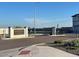 Gated community entrance with brick signage, landscaping and a secure access point for residents at 17260 W Daley Ln, Surprise, AZ 85387