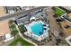 Aerial view of a community pool with lounge chairs and a covered seating area next to manicured landscaping at 17260 W Daley Ln, Surprise, AZ 85387