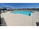 Community pool with lounge seating and a table with chairs, providing a luxurious and relaxing outdoor experience at 17260 W Daley Ln, Surprise, AZ 85387