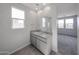 Bathroom features double sinks, granite countertops, a large mirror, and natural light from window at 17266 W Daley Ln, Surprise, AZ 85387
