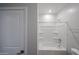 Neutral bathroom with tub-shower combo, grab bars, and integrated shelving at 17266 W Daley Ln, Surprise, AZ 85387