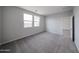 Bedroom features neutral walls and carpet with double windows and an open doorway at 17266 W Daley Ln, Surprise, AZ 85387
