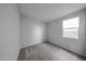 Bright, carpeted bedroom with a window and ample natural light at 17266 W Daley Ln, Surprise, AZ 85387