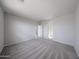 Large bedroom with neutral tones and carpet, and an open doorway to additional rooms at 17266 W Daley Ln, Surprise, AZ 85387