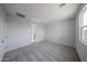 Spacious bedroom with plush carpet and neutral walls ready for personalization and decor at 17266 W Daley Ln, Surprise, AZ 85387