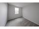 Spare bedroom with soft carpeting, neutral paint, and bright window at 17266 W Daley Ln, Surprise, AZ 85387