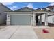 Charming home featuring a concrete driveway, brick accents, and a covered entryway at 17266 W Daley Ln, Surprise, AZ 85387