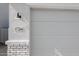 Close-up of the garage door with a house number and exterior light fixture at 17266 W Daley Ln, Surprise, AZ 85387