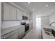 Modern kitchen area shows the stainless steel stove and microwave oven above at 17266 W Daley Ln, Surprise, AZ 85387