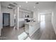 Open-concept kitchen with an island, stainless steel appliances, and modern finishes at 17266 W Daley Ln, Surprise, AZ 85387