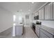 Modern kitchen featuring an island, subway tile backsplash, and stainless appliances at 17266 W Daley Ln, Surprise, AZ 85387