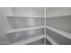 Walk-in pantry with adjustable white shelves for organized storage space at 17266 W Daley Ln, Surprise, AZ 85387