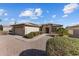 Single-story home with desert landscaping, a two-car garage, and a neutral color scheme at 17572 W Calistoga Dr, Surprise, AZ 85387