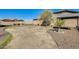 A backyard with a covered patio area and desert landscaping at 1785 S 222Nd Ln, Buckeye, AZ 85326