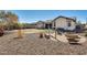 Spacious backyard with a fire pit area, hammock, and desert landscaping at 1785 S 222Nd Ln, Buckeye, AZ 85326