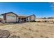 Expansive backyard with patio area, desert landscaping, and ample space for outdoor activities at 1785 S 222Nd Ln, Buckeye, AZ 85326