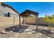 A backyard with a covered patio area and desert landscaping at 1785 S 222Nd Ln, Buckeye, AZ 85326