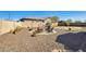 Backyard showcasing fire pit area with stone ground cover, comfortable seating, and desert landscaping at 1785 S 222Nd Ln, Buckeye, AZ 85326