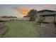 Backyard featuring green lawn, desert landscaping, and an open view at 1785 S 222Nd Ln, Buckeye, AZ 85326