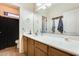 Well-lit bathroom featuring a spacious vanity, large mirror, and convenient towel hooks at 1785 S 222Nd Ln, Buckeye, AZ 85326