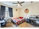 Comfortable bedroom with window, desk, decorations, and ceiling fan at 1785 S 222Nd Ln, Buckeye, AZ 85326