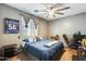 Comfortable bedroom with window, grey walls, ceiling fan, and sports decoration at 1785 S 222Nd Ln, Buckeye, AZ 85326