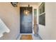 Inviting front entrance with a decorated door, security camera, and a decorative pot at 1785 S 222Nd Ln, Buckeye, AZ 85326