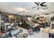 Spacious garage equipped with storage racks, multiple ceiling fans, and room for recreational vehicles at 1785 S 222Nd Ln, Buckeye, AZ 85326