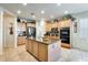 This kitchen is equipped with wooden cabinets, granite countertops, a large island and stainless steel appliances at 1785 S 222Nd Ln, Buckeye, AZ 85326