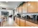 Well-lit kitchen features wooden cabinets, tile backsplash, stainless steel appliances and view of living area at 1785 S 222Nd Ln, Buckeye, AZ 85326