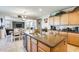 The kitchen is equipped with an island sink, bar seating, and seamlessly connects to the dining and living areas at 1785 S 222Nd Ln, Buckeye, AZ 85326