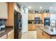 Beautiful kitchen featuring stainless steel appliances, wooden cabinetry, and tile flooring at 1785 S 222Nd Ln, Buckeye, AZ 85326