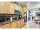 This spacious kitchen offers wood cabinets, granite countertops, stainless steel appliances, and tile backsplash at 1785 S 222Nd Ln, Buckeye, AZ 85326