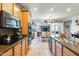 Modern kitchen featuring stainless steel appliances, mosaic backsplash, and wooden cabinetry at 1785 S 222Nd Ln, Buckeye, AZ 85326