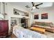 Comfortable living room features a ceiling fan, built-in shelving, and cozy seating at 1785 S 222Nd Ln, Buckeye, AZ 85326