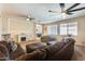 Bright living room featuring a corner fireplace, recessed lighting, and tan walls, creating a cozy atmosphere at 1785 S 222Nd Ln, Buckeye, AZ 85326