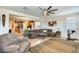 Spacious living room with a large sofa, area rug, and ample natural light at 1785 S 222Nd Ln, Buckeye, AZ 85326