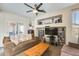 Cozy living room featuring a fireplace, built-in shelving, and sliding glass doors at 1785 S 222Nd Ln, Buckeye, AZ 85326