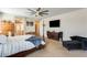Spacious main bedroom featuring a large bed, TV, ceiling fan, and decorative furnishings at 1785 S 222Nd Ln, Buckeye, AZ 85326