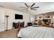 Spacious main bedroom with a view into another entertainment space, TV, ceiling fan at 1785 S 222Nd Ln, Buckeye, AZ 85326