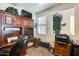 Functional home office with custom wood built-ins, a window, and ample storage solutions at 1785 S 222Nd Ln, Buckeye, AZ 85326