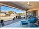 Spacious covered patio featuring a built-in grill, bar seating, and a relaxing lounge area at 1785 S 222Nd Ln, Buckeye, AZ 85326