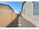 Gravel-covered side yard with a stone pathway and high block wall at 1785 S 222Nd Ln, Buckeye, AZ 85326
