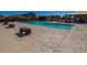 Outdoor pool with benches and an open air structure with picnic seating in a community setting at 18227 W Daley Ln, Surprise, AZ 85387